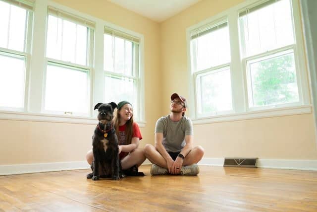 if your pet doesnt like your partner he may ignore them like this dog sitting next to his owner