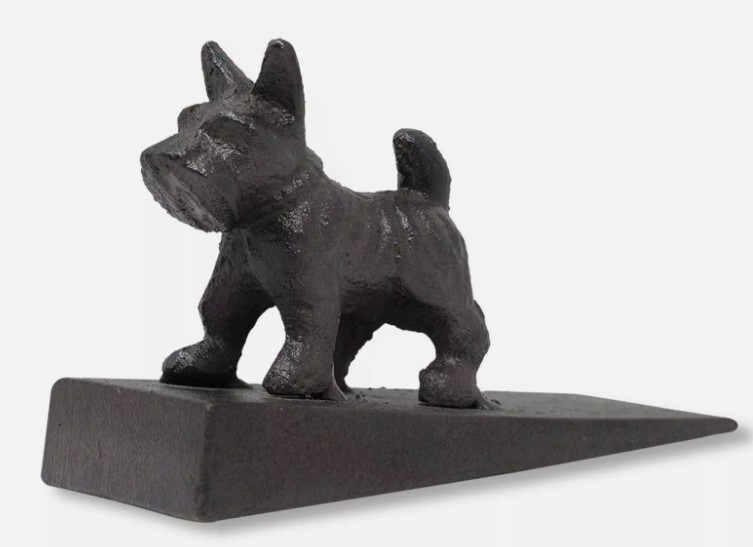 A black cast iron doorstop shaped like a standing dog with its tail up, set on a wedge-shaped base. This charming piece makes an ideal gift for pet lovers, blending functionality with whimsical design.