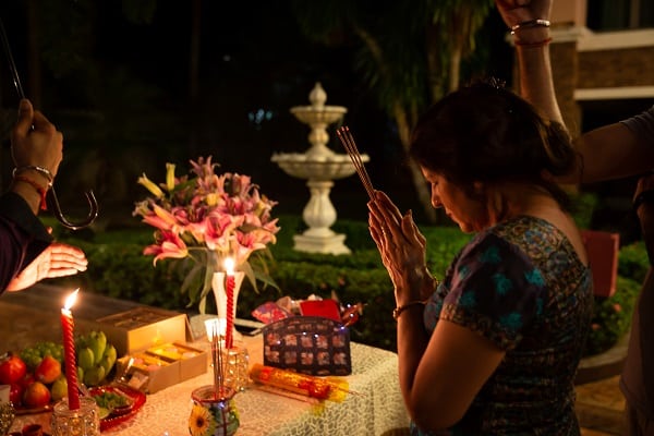 A family prays over a traditional mid autumn festival dinner. the moon festival is a time or family and giving thanks