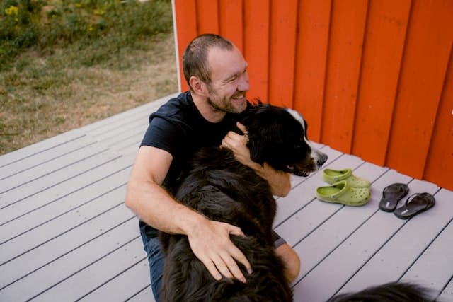 a man hugging a dog
