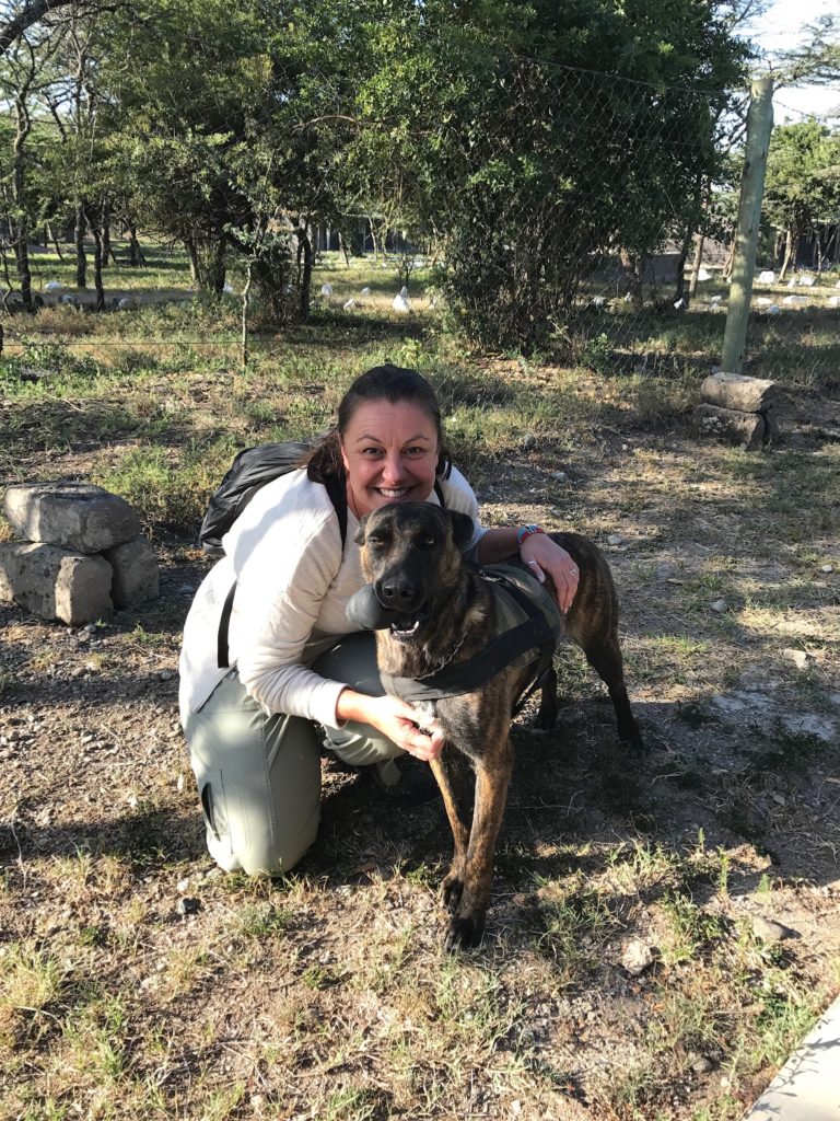 Maria Alojaman with a dog in Africa
