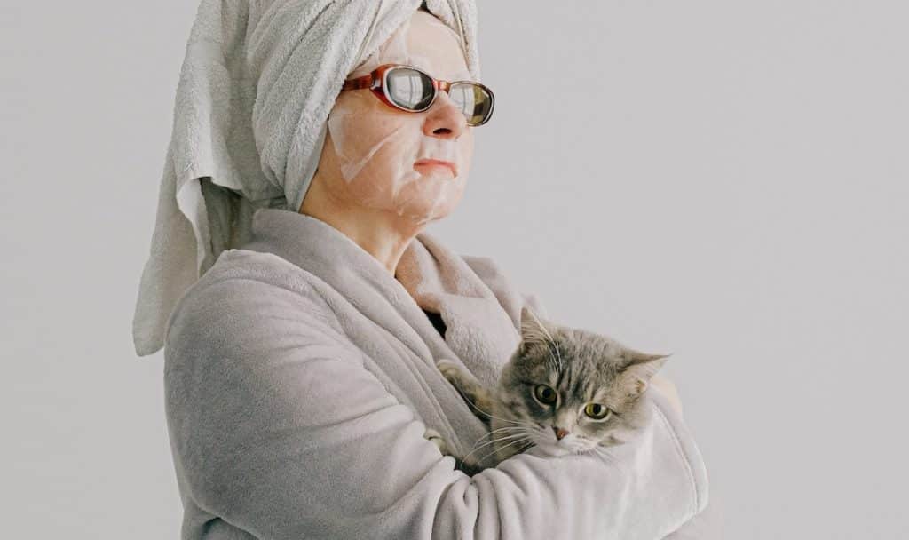 an old lady with a cat is nicknamed the neighbourhood's crazy cat lady