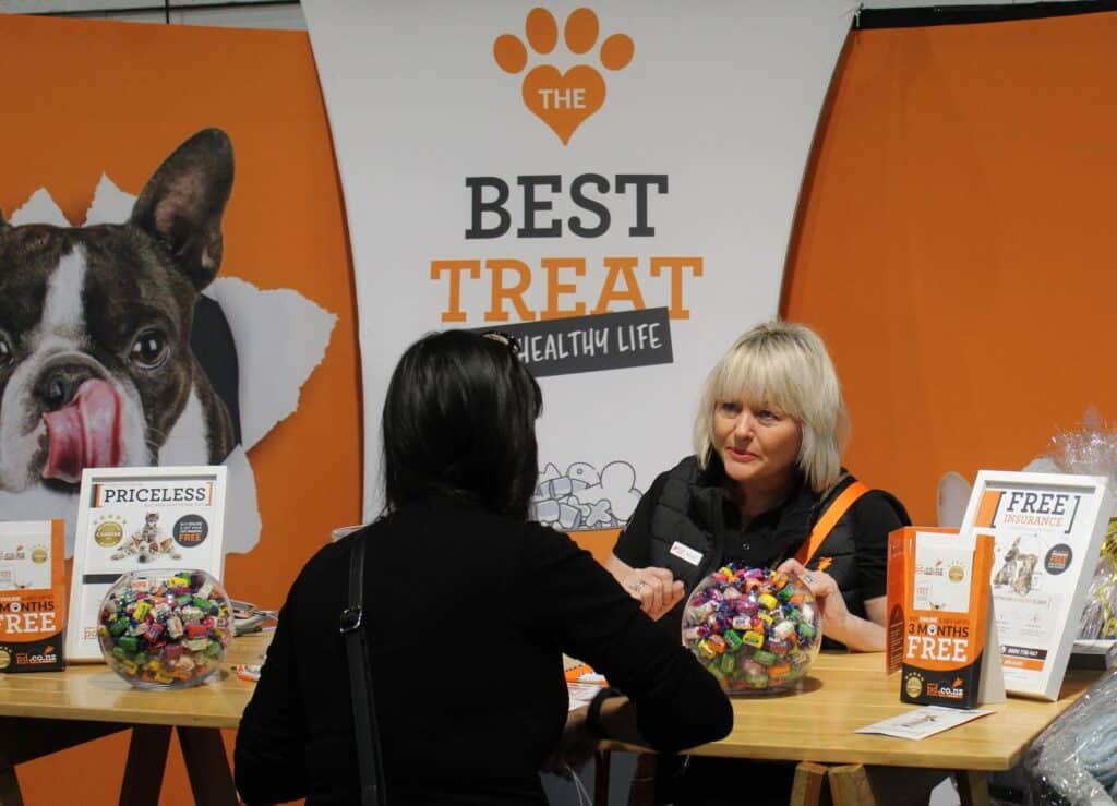 Michelle Le Long, COO at PD Insurance speaks to a visitor at the Auckland Pet Expo