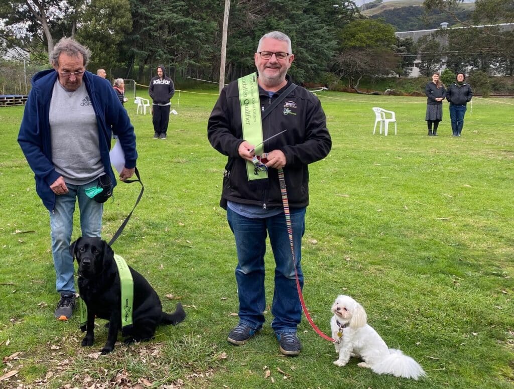 Dogs NZ Director, Steven Thompson with his dog Stella, a Shih Tzu X together with their CGC classmates Ian & Ella the black Lab 