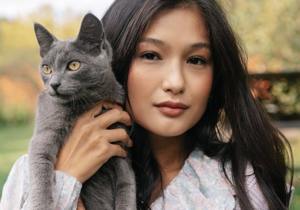 woman holds her cat lovingly