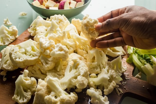 A dog owner has been Googling what human food is good for dogs and is prepping cauliflower bits to try out