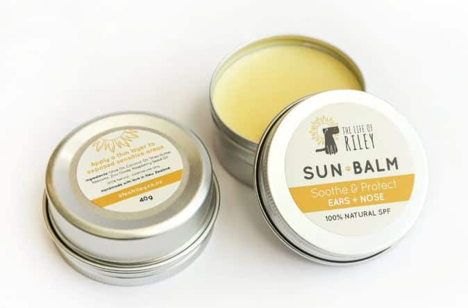 A tin of sun balm for dogs on a white surface.