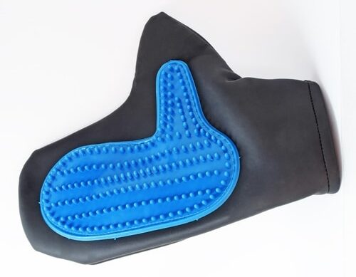 A black and blue dog grooming glove for shedding on a white surface.