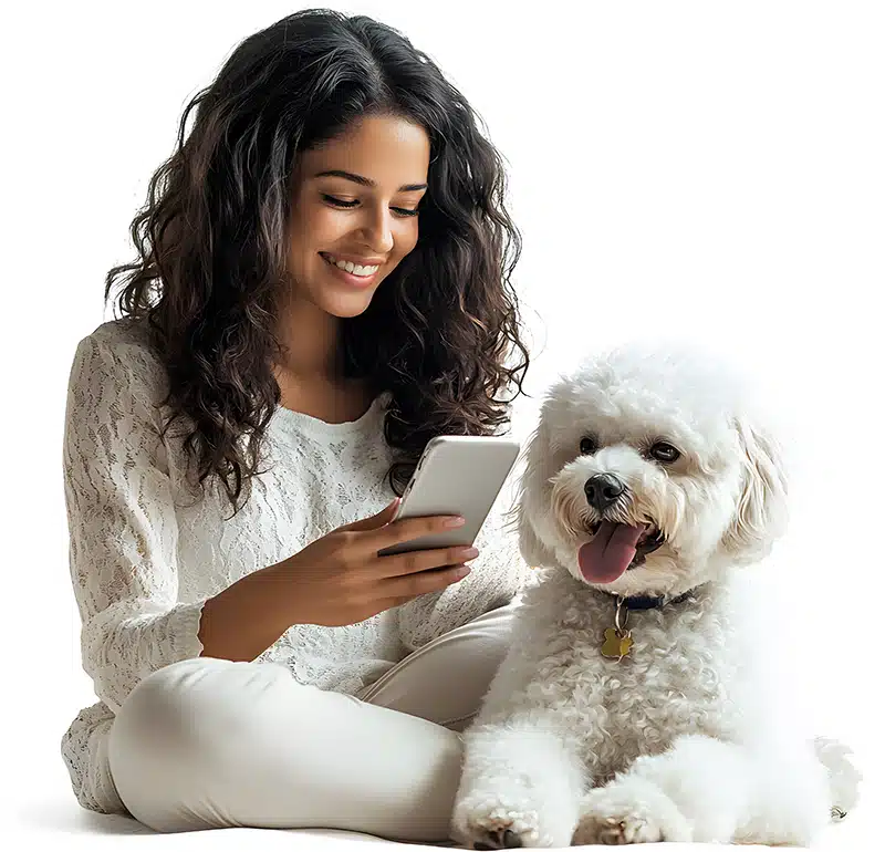A woman sits cross-legged with a white fluffy dog, smiling while looking at her smartphone against a white background, perhaps taking part in a human-pet bond survey.